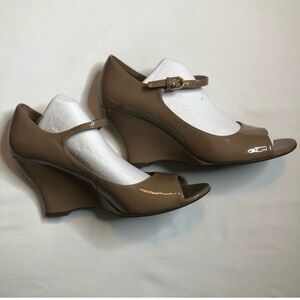 Franco Sarto tan patten leather wedge with peek a boo toe.